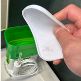 Lid for Waterpik Traveler being held over the water tank of a Waterpik Traveler Water Flosser WP-300.