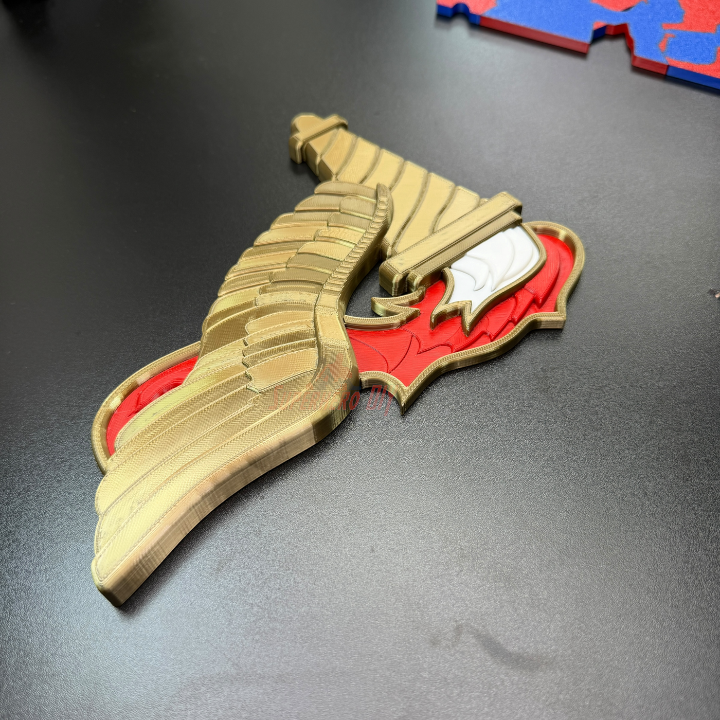 Army Pathfinder Badge display insignia with winged torch design in gold and red colors.