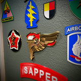Army Pathfinder Badge display insignia featuring a winged torch design on a wall.