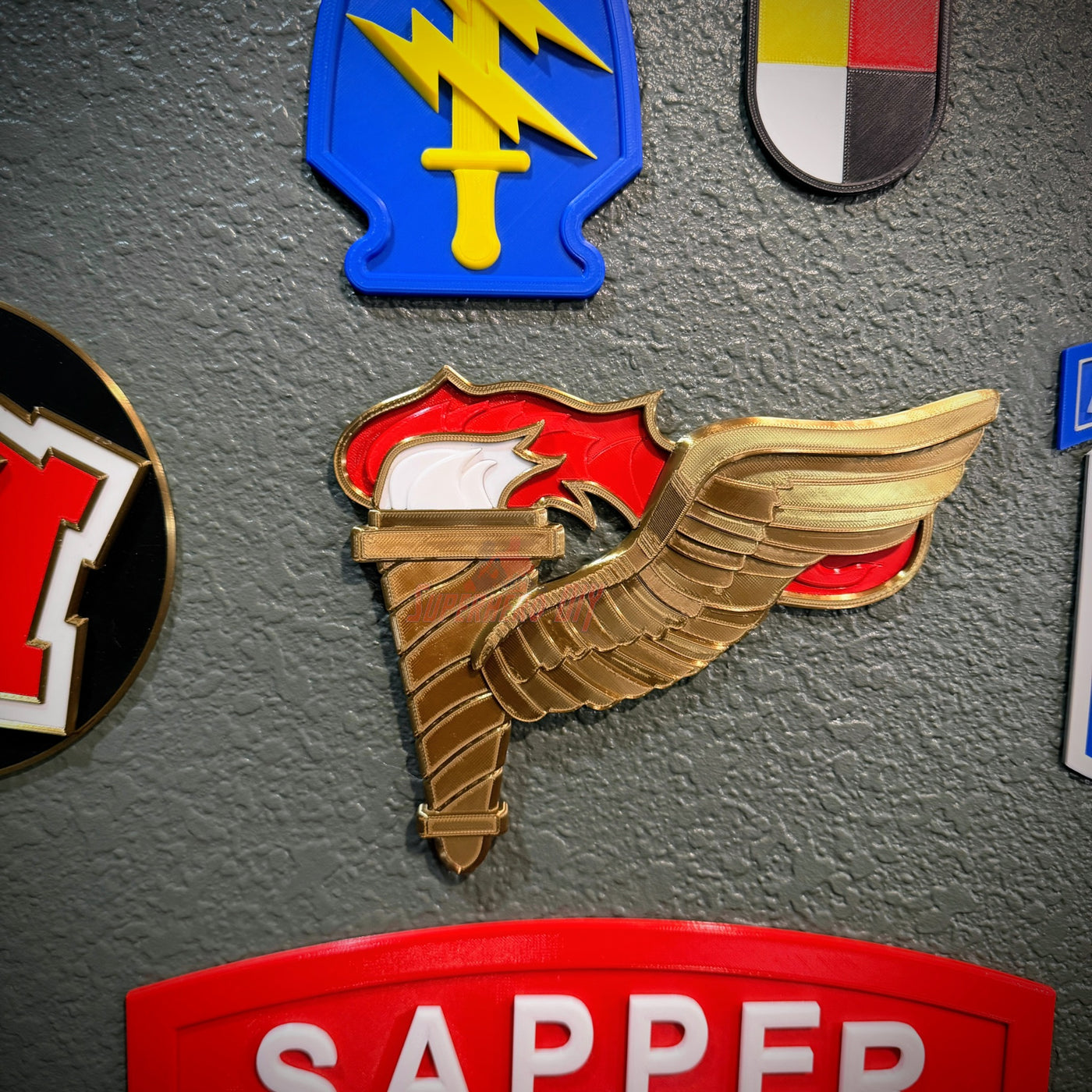 Army Pathfinder Badge display insignia featuring winged torch design on a wall.