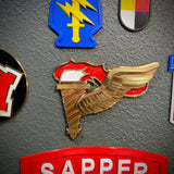 Army Pathfinder Badge display insignia featuring winged torch design on a wall.