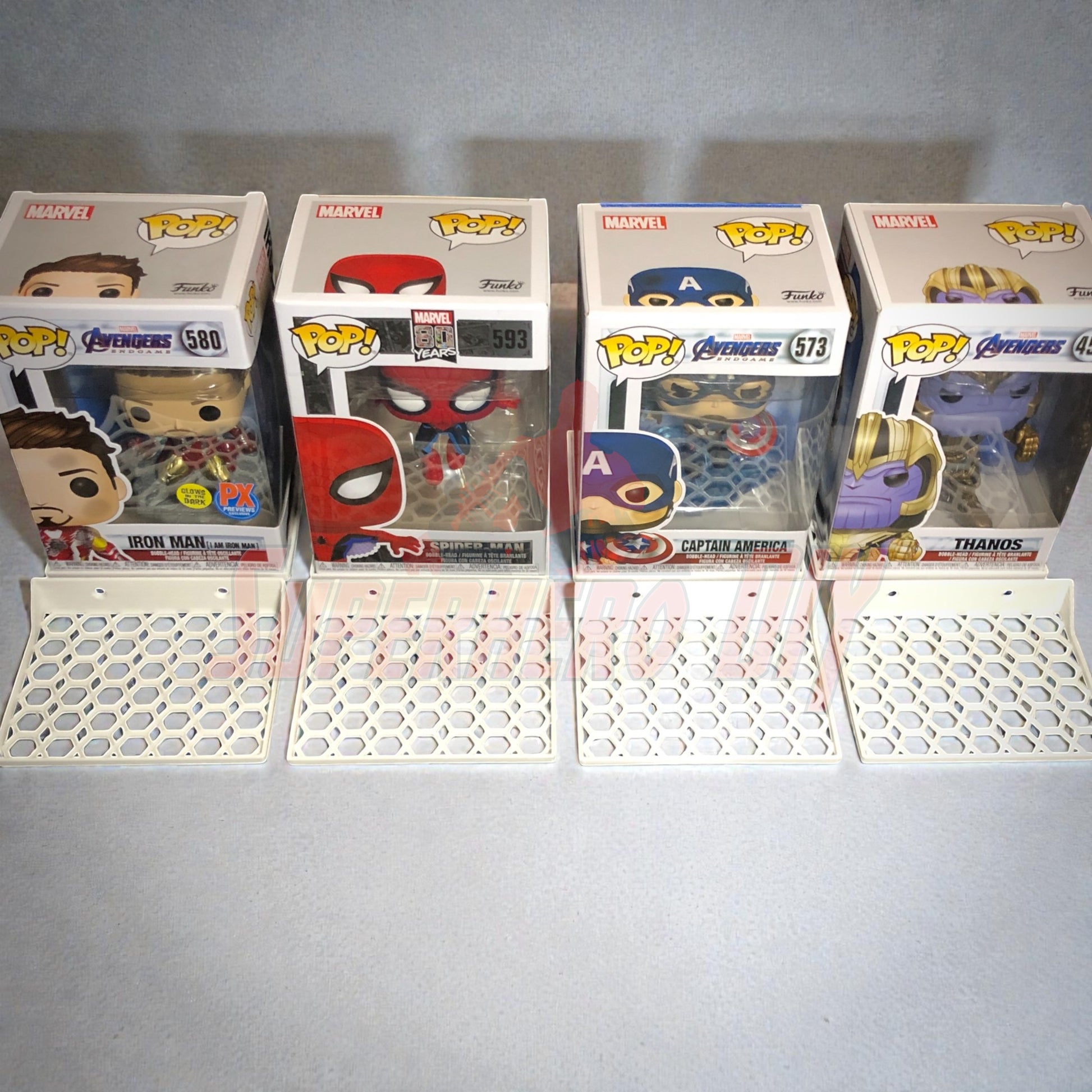 Hexagon Funko Pop display shelves showcasing Marvel Pops in box with honeycomb base for collectors.