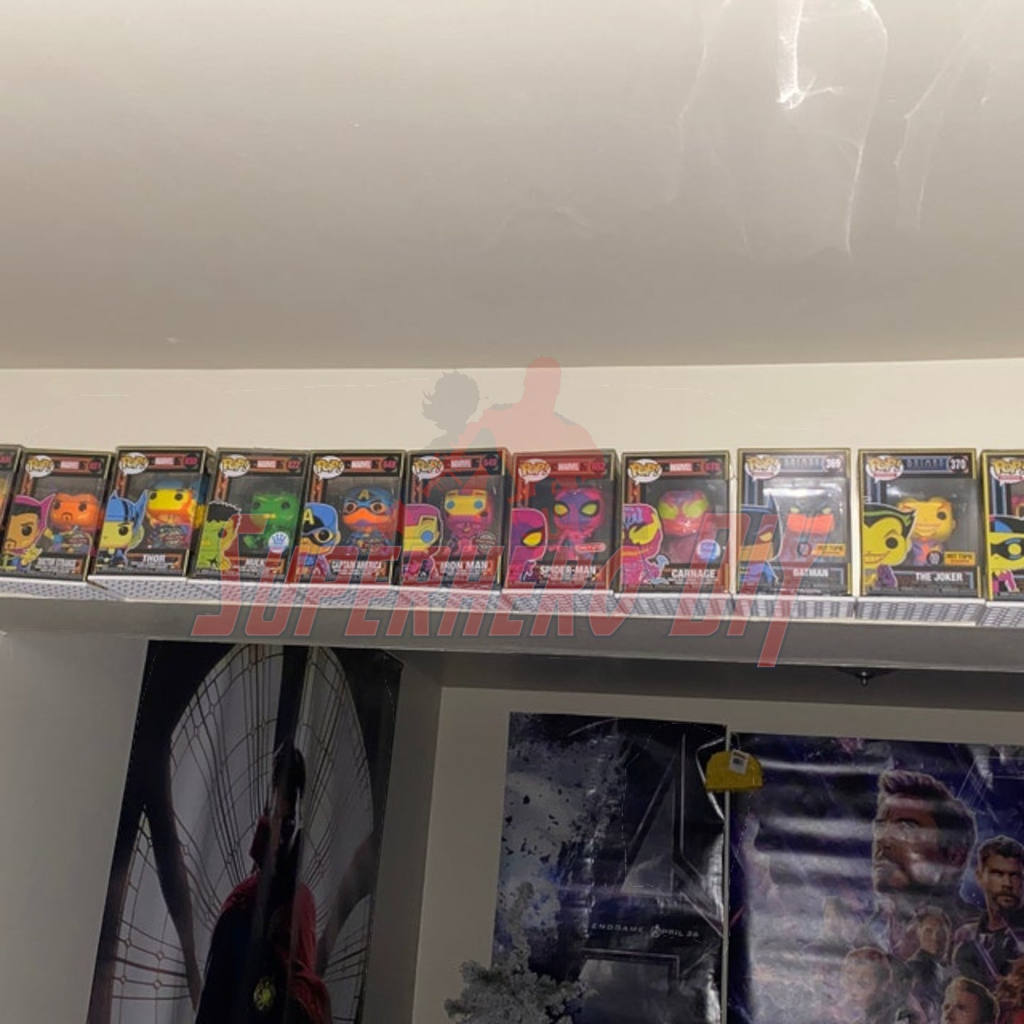 Hexagon Funko Pop display shelves showcasing boxed figures on wall-mounted floating shelf.