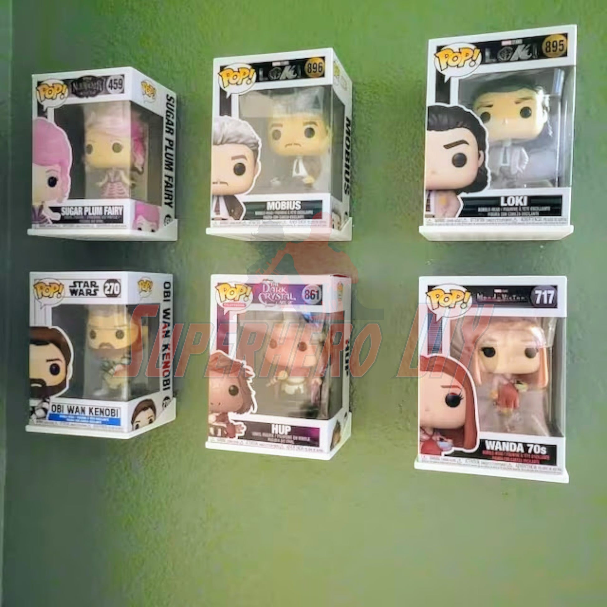 Hexagon Funko Pop display shelves showcasing six boxed collectibles on a green wall.
