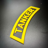 3D tanker tab in bright yellow featuring raised lettering and border for display purposes.