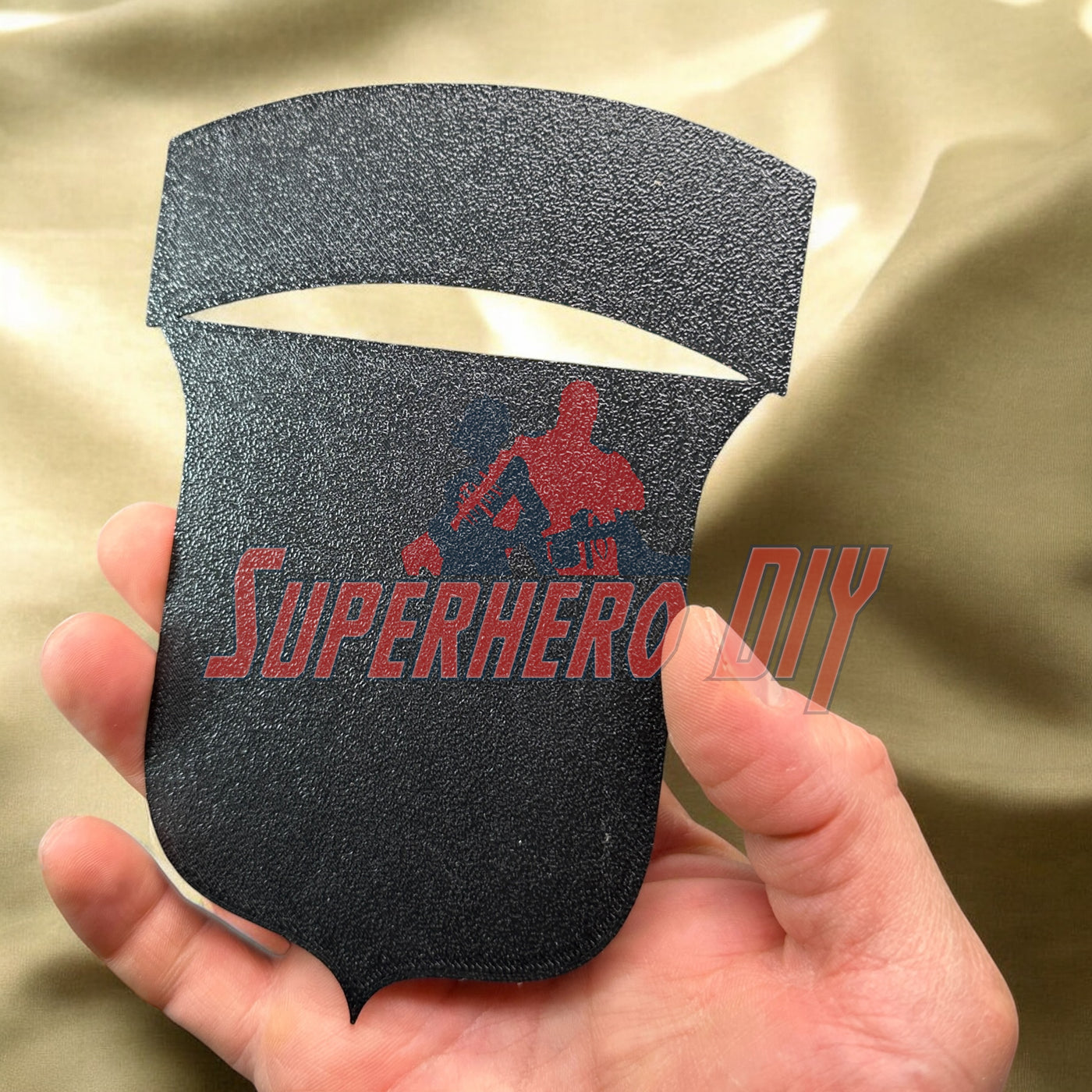3D-printed 101st Airborne Division display insignia being held for display