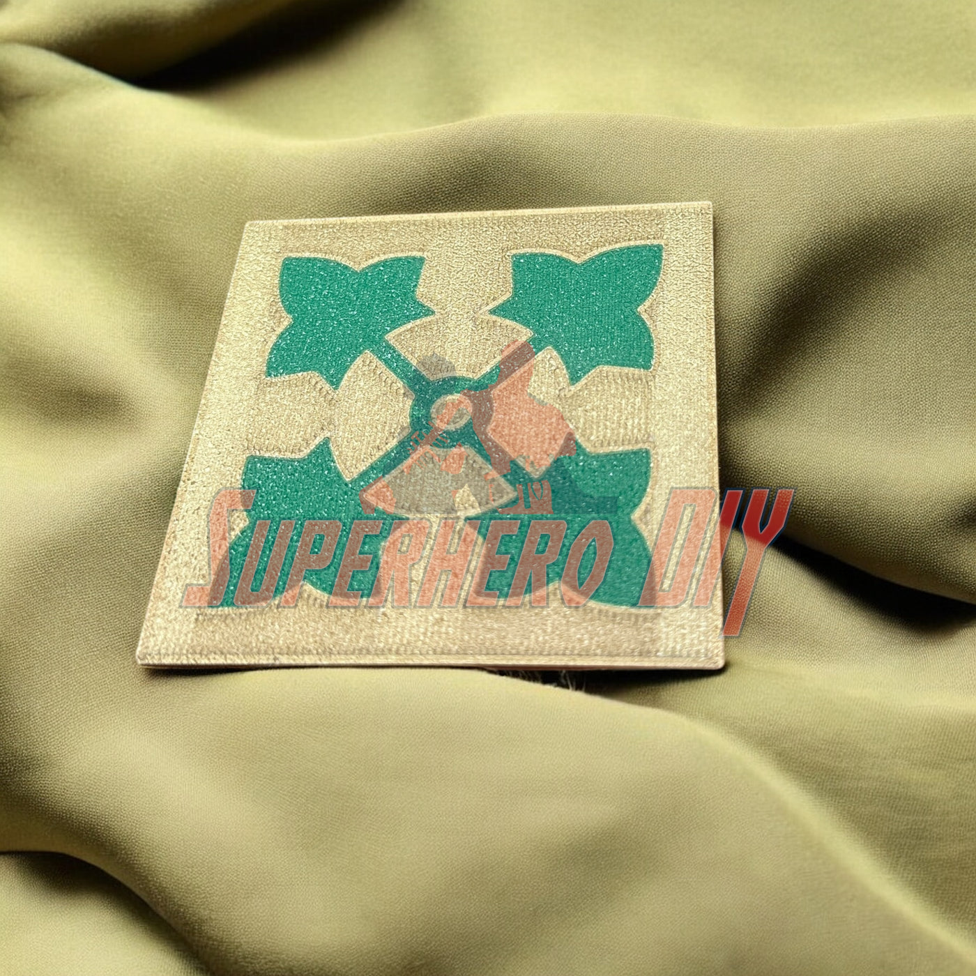 4th Infantry Division display insignia patch on fabric background, showcasing iconic ivy leaf design.