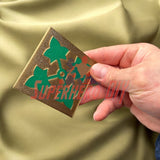 Hand holding 4th Infantry Division display insignia with green ivy leaf design, crafted by a U.S. Army veteran, multiple sizes available.