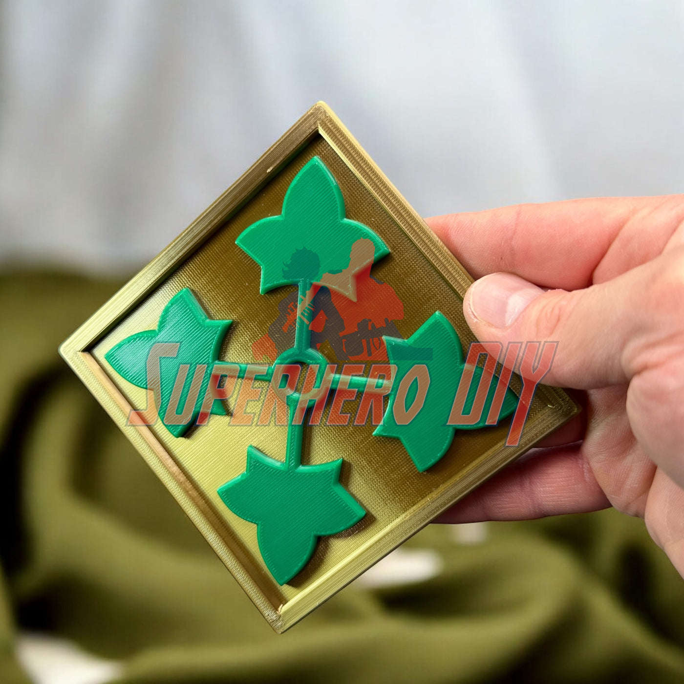 4th Infantry Division display insignia 3D-printed ivy leaf patch held by a hand