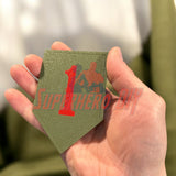 Hand holding 1st Infantry Division display insignia, Big Red One patch, olive green background, perfect for wall display or shadowbox.