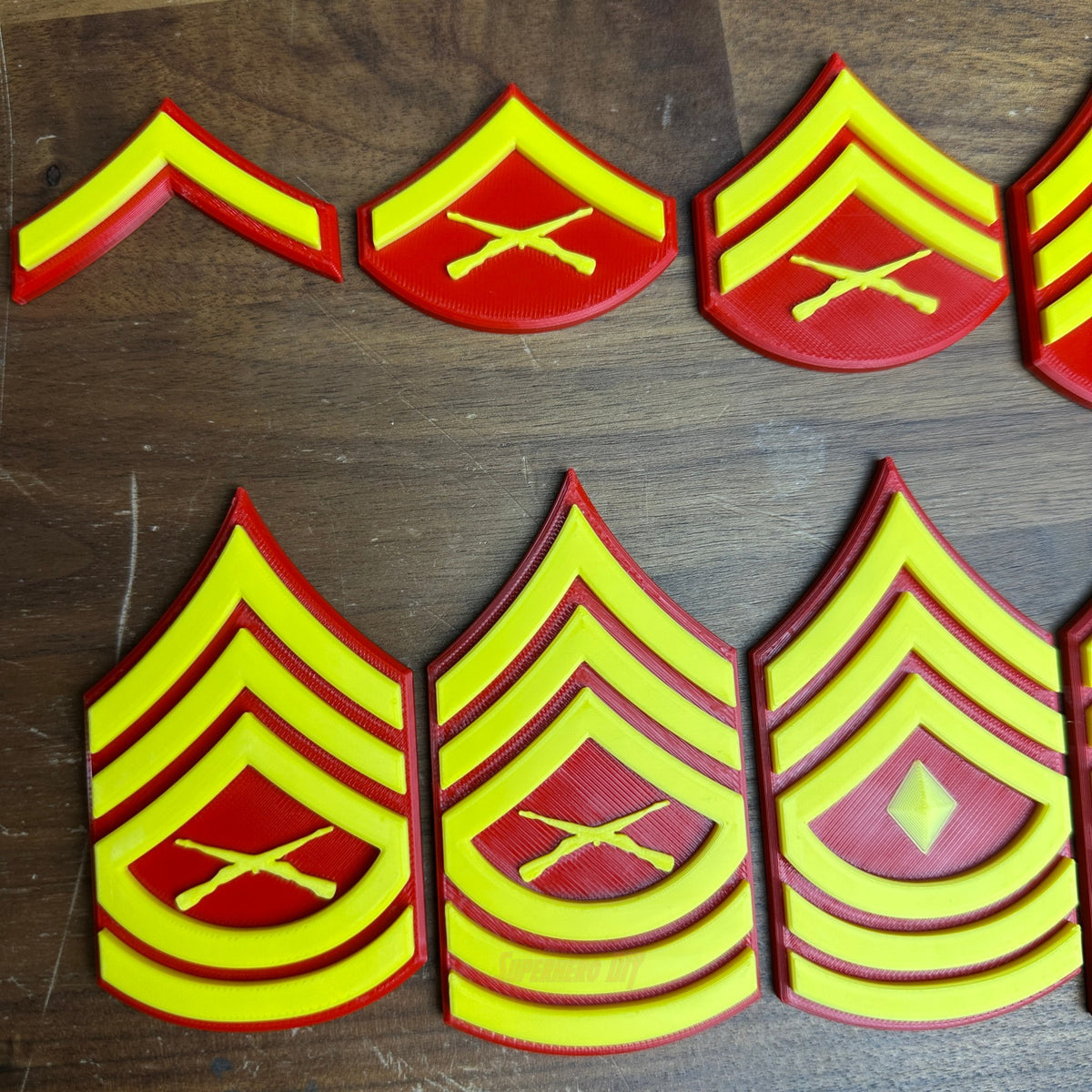USMC enlisted rank insignia in red and yellow, showcasing multiple Marine Corps ranks, including Private First Class to Sergeant Major.