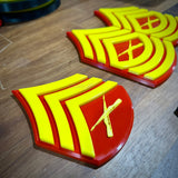 USMC enlisted rank insignia replicas in red and yellow colors, showcasing detailing for Marine Corps pride.