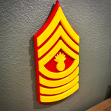 USMC enlisted rank insignia, detailed yellow and red design, showcasing Marine Corps NCO rank.