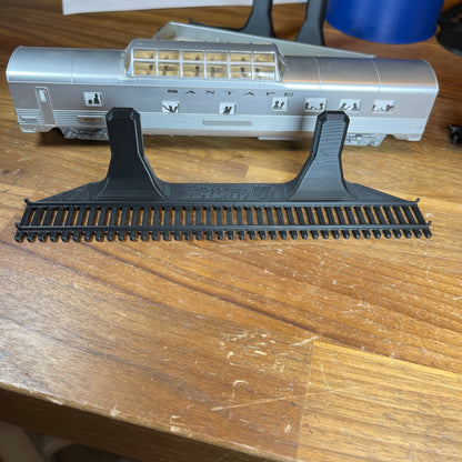 HO-scale train display shelf showcasing a model train car on a wall-mounted track.