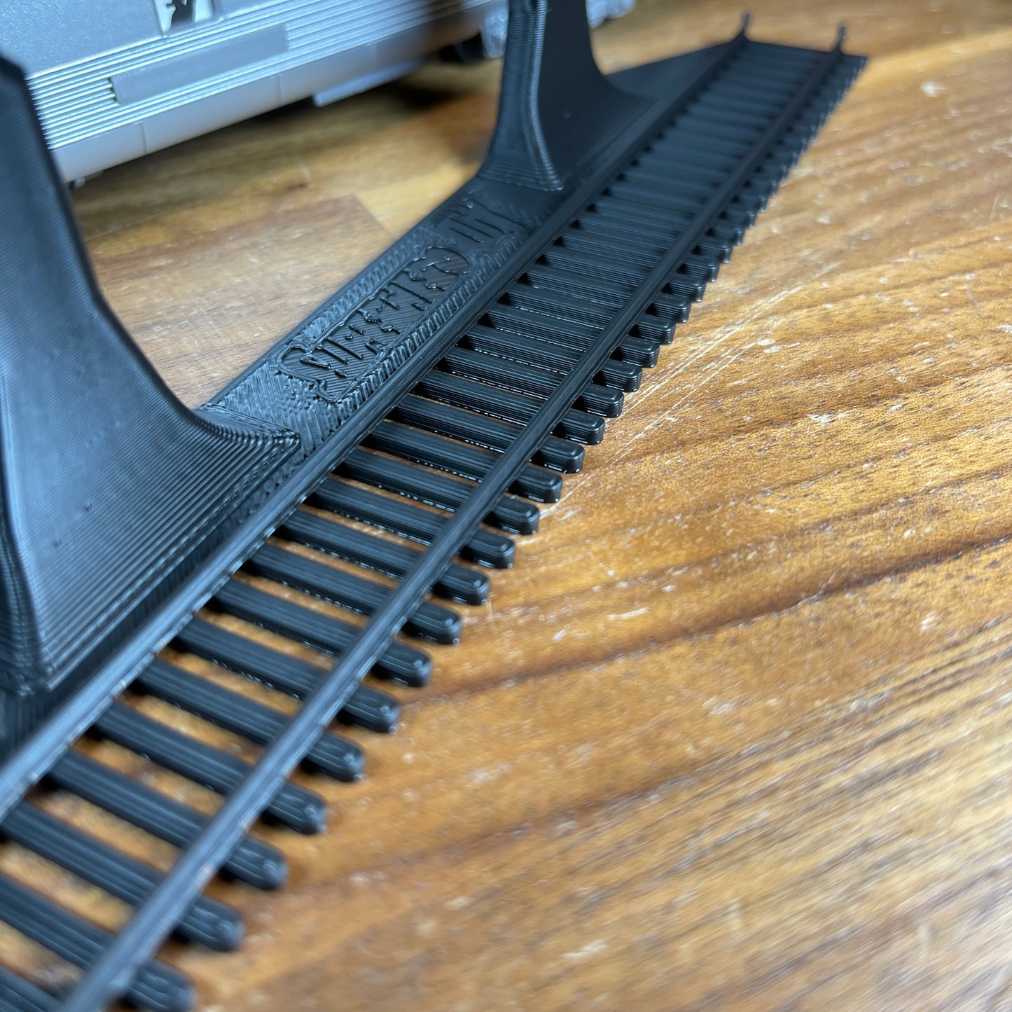 HO-scale train display shelf track detail showing realistic rails and design for wall-mounted display.