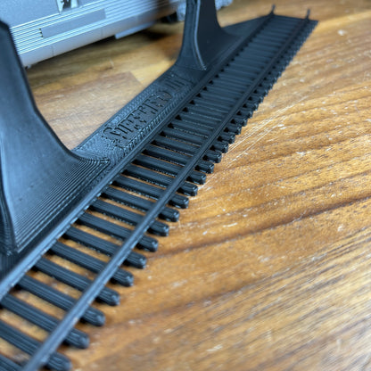 HO-scale train display shelf track detail showing realistic rails and design for wall-mounted display.