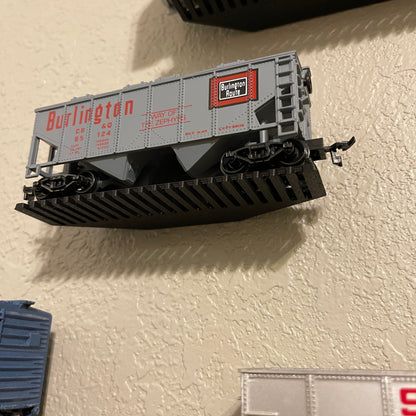 HO-scale train display shelf featuring a Burlington car mounted on the wall.